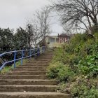 Whimsical painting of tree-lined pathway to blue tower