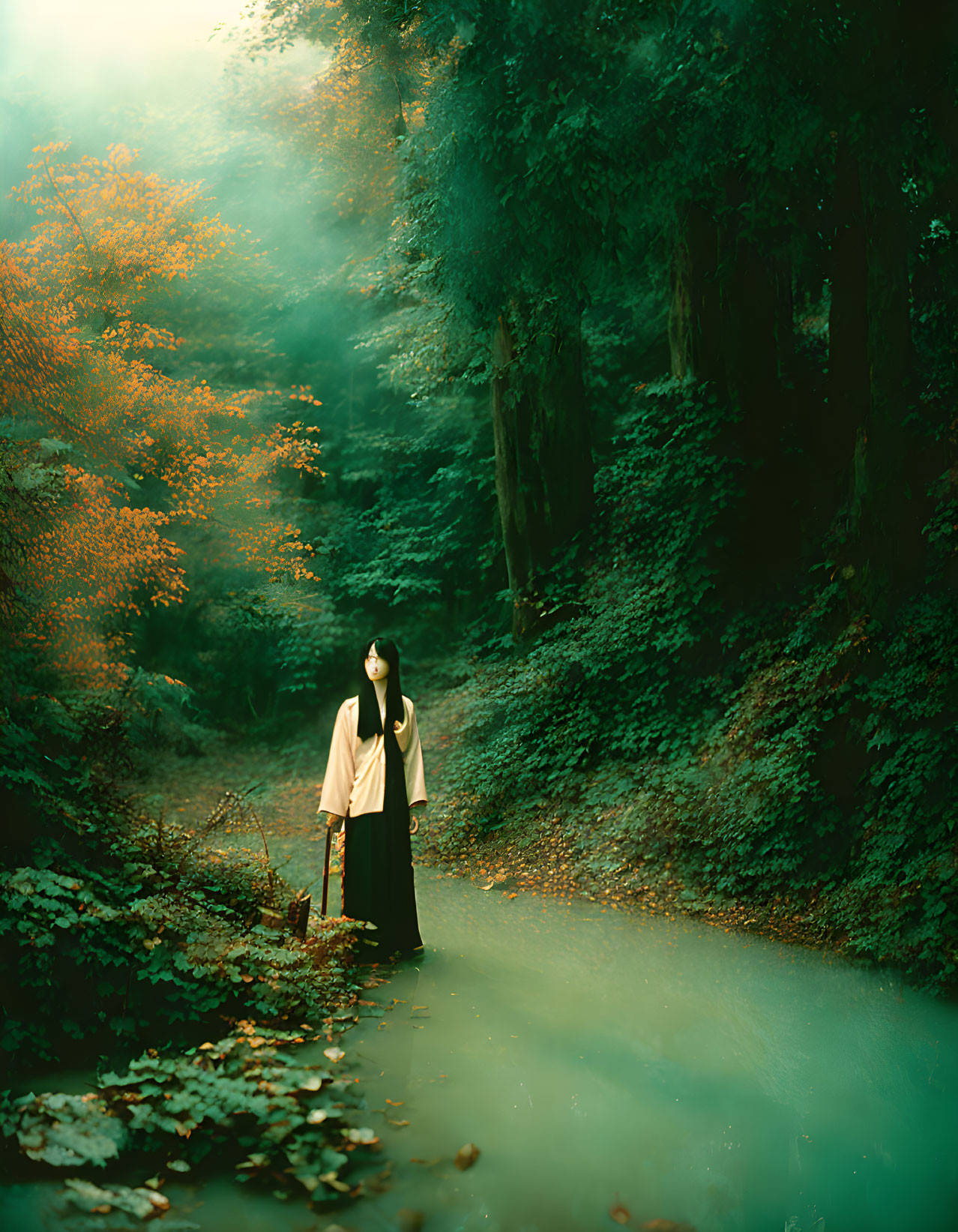 Person in Light Top and Dark Skirt in Misty Forest with Autumn Foliage