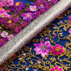 Ornate silver sword with engraved patterns on dark blue background with gold floral designs and pink flowers.