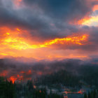 Vibrant orange sunset over misty mountain landscape