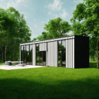 Modern Black and White House with Large Windows and Green Surroundings