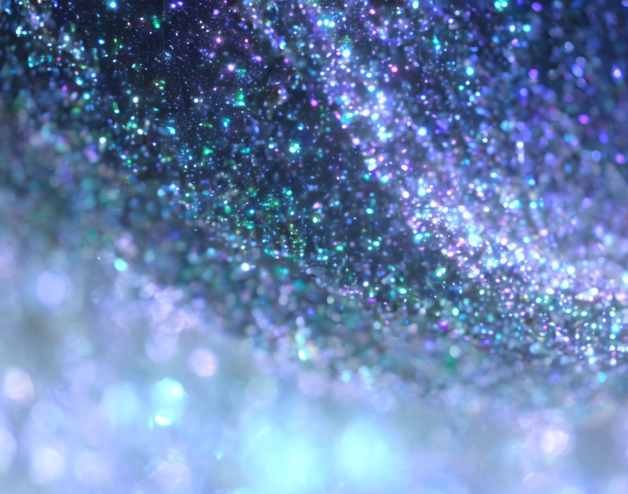 Close-Up of Glittering Blue, Green, and Purple Particles Creating Galaxy-Like Bokeh