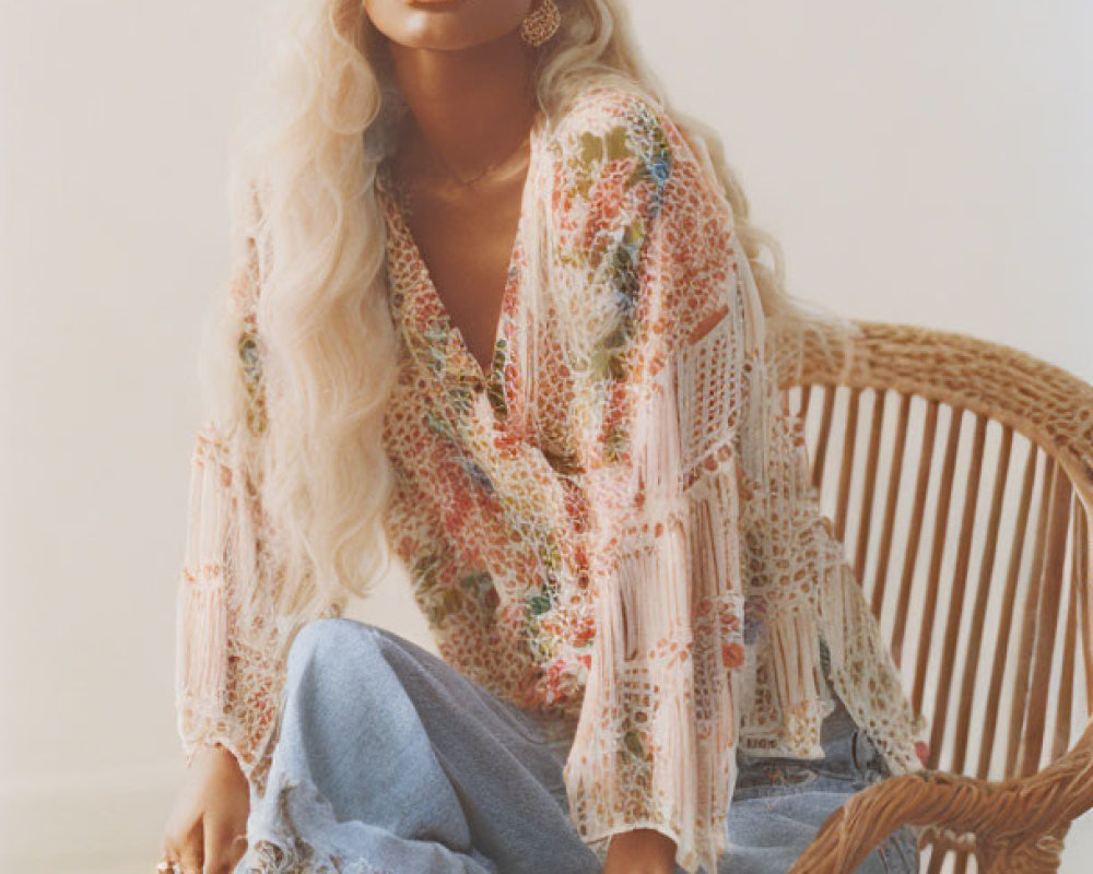 Woman with Wavy Hair Sitting on Rattan Chair in Softly Lit Room