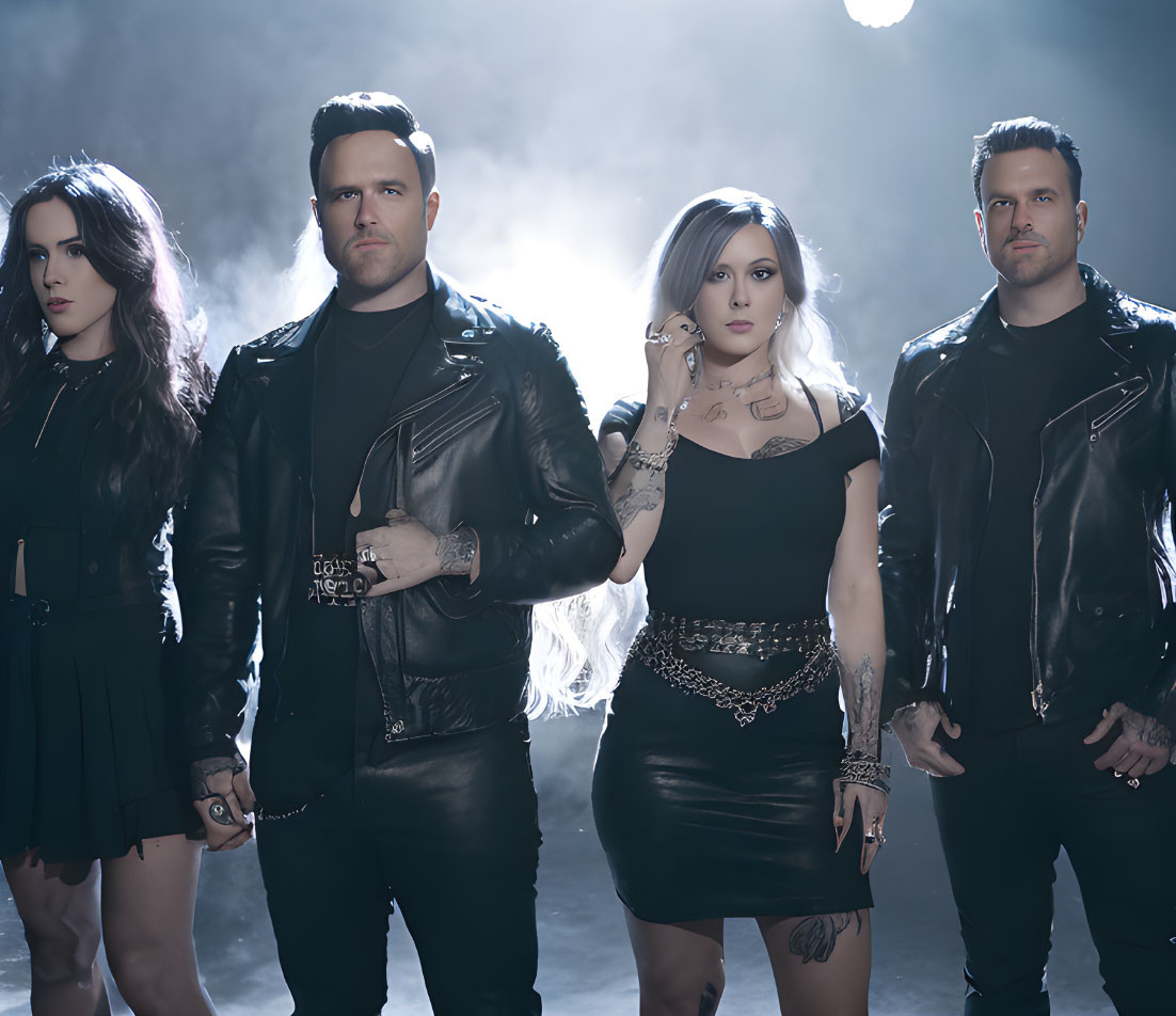 Four people in black leather outfits pose confidently against a smoky backdrop