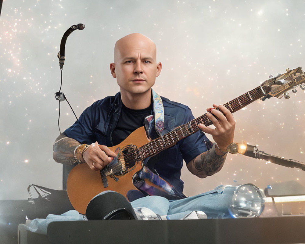 Bald Musician Performing with Acoustic Guitar on Stage