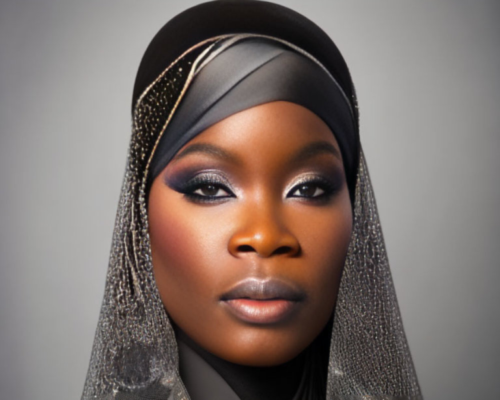 Portrait of person with headscarf, dramatic eye makeup, and sparkling details.