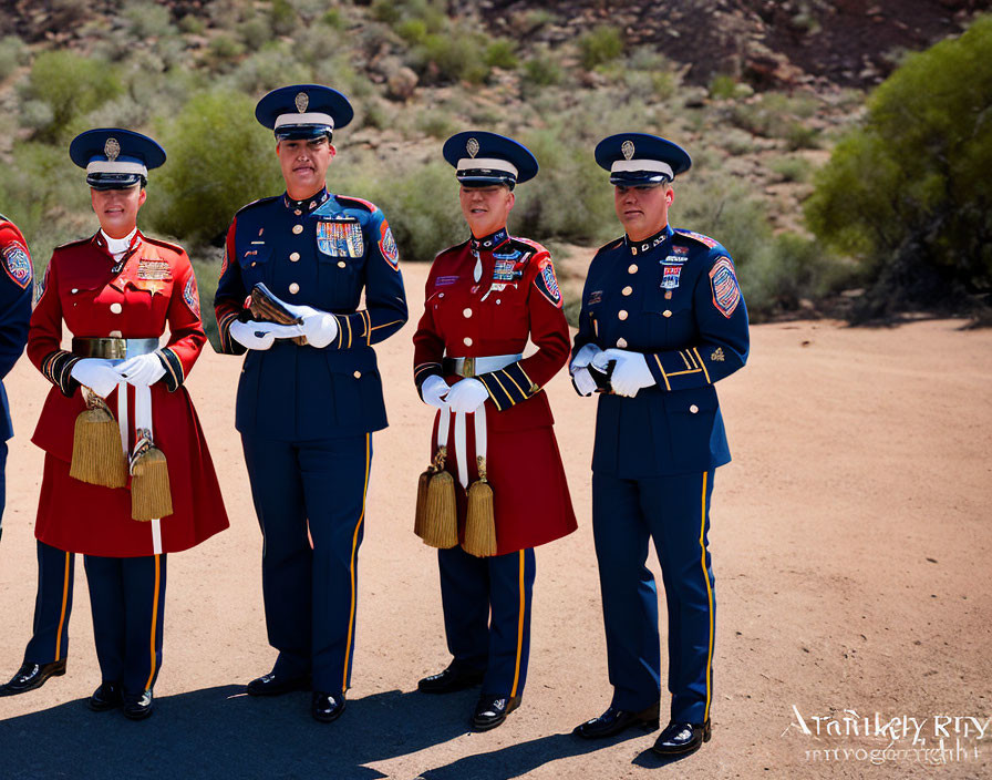 Four uniformed individuals in ceremonial attire outdoors with red and blue jackets, white gloves, and embellished