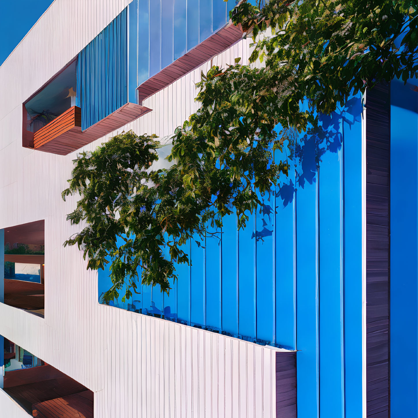 Blue and White Geometric Building Facade with Tree Branches