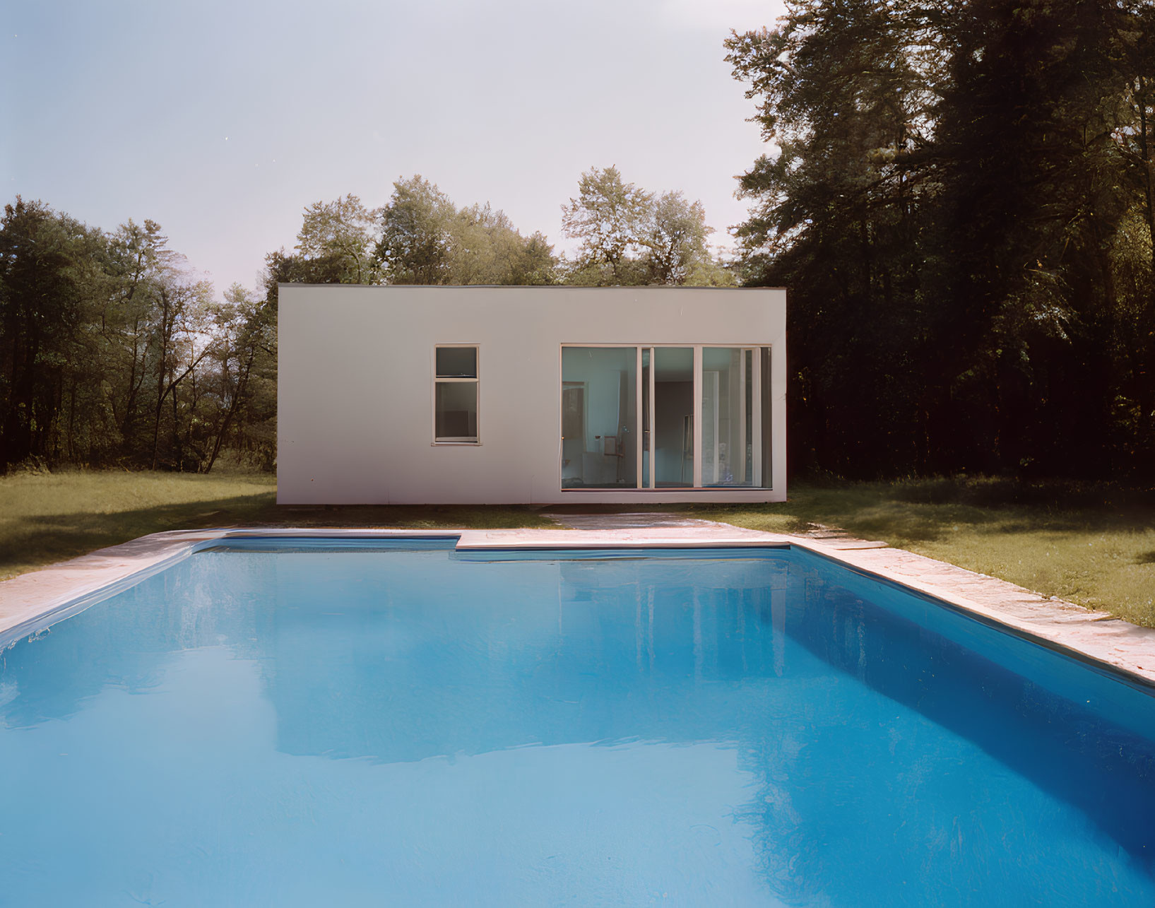 Contemporary White House with Large Windows and Outdoor Pool