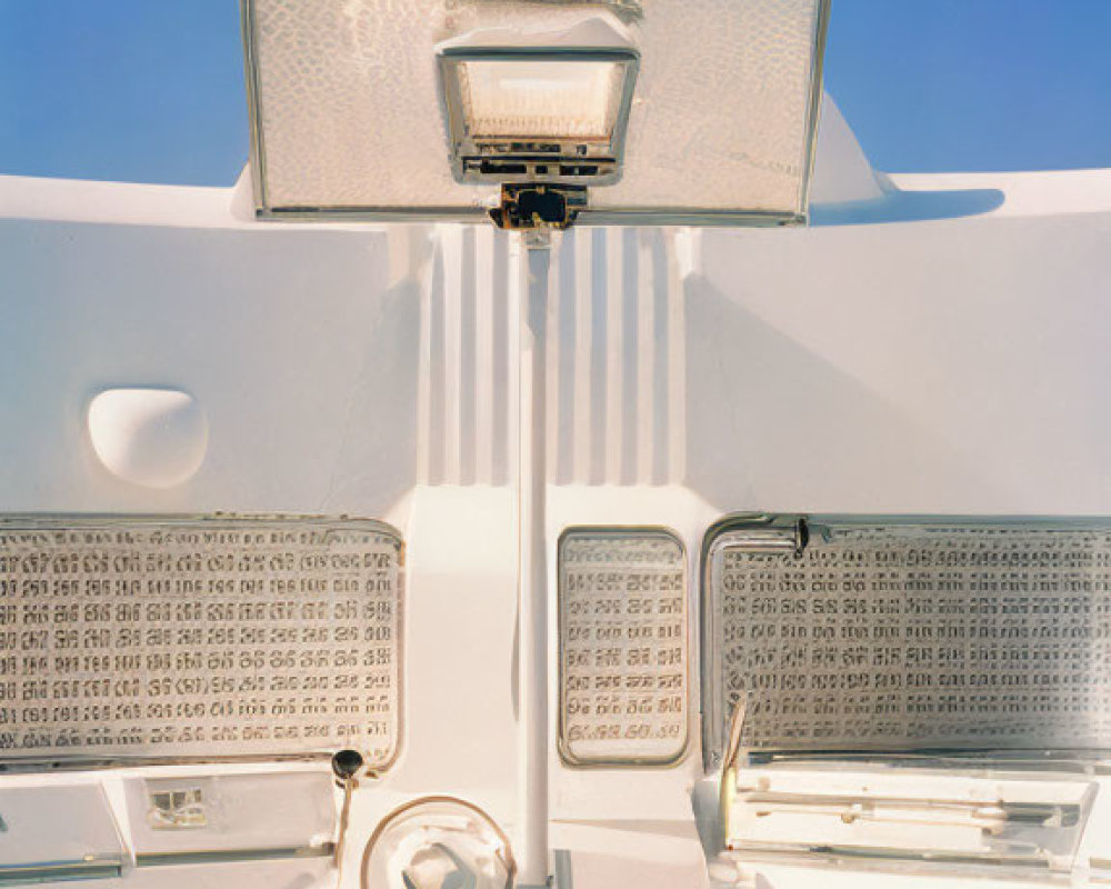 White Car Trunk Open Against Blue Sky: Rear Light and Interior Details