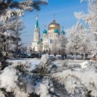 Snowy Landscape with Frosted Trees and Colorful Orthodox Cathedral