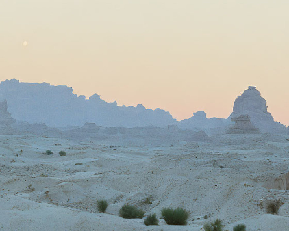 Desert landscape at dusk with rock formations and moon