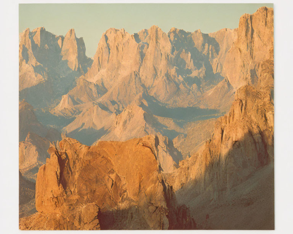 Majestic mountain range under warm sunlight and clear sky