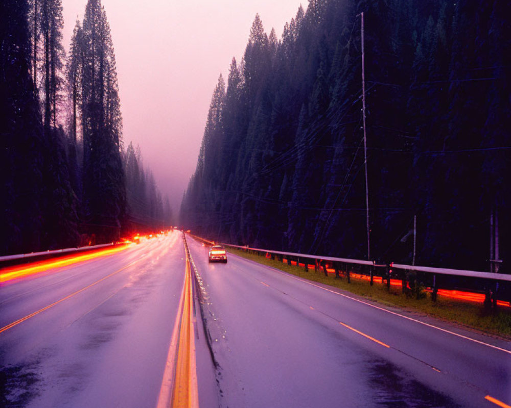 Vehicle drives on wet road at dusk with illuminated headlights and streaking tail lights.