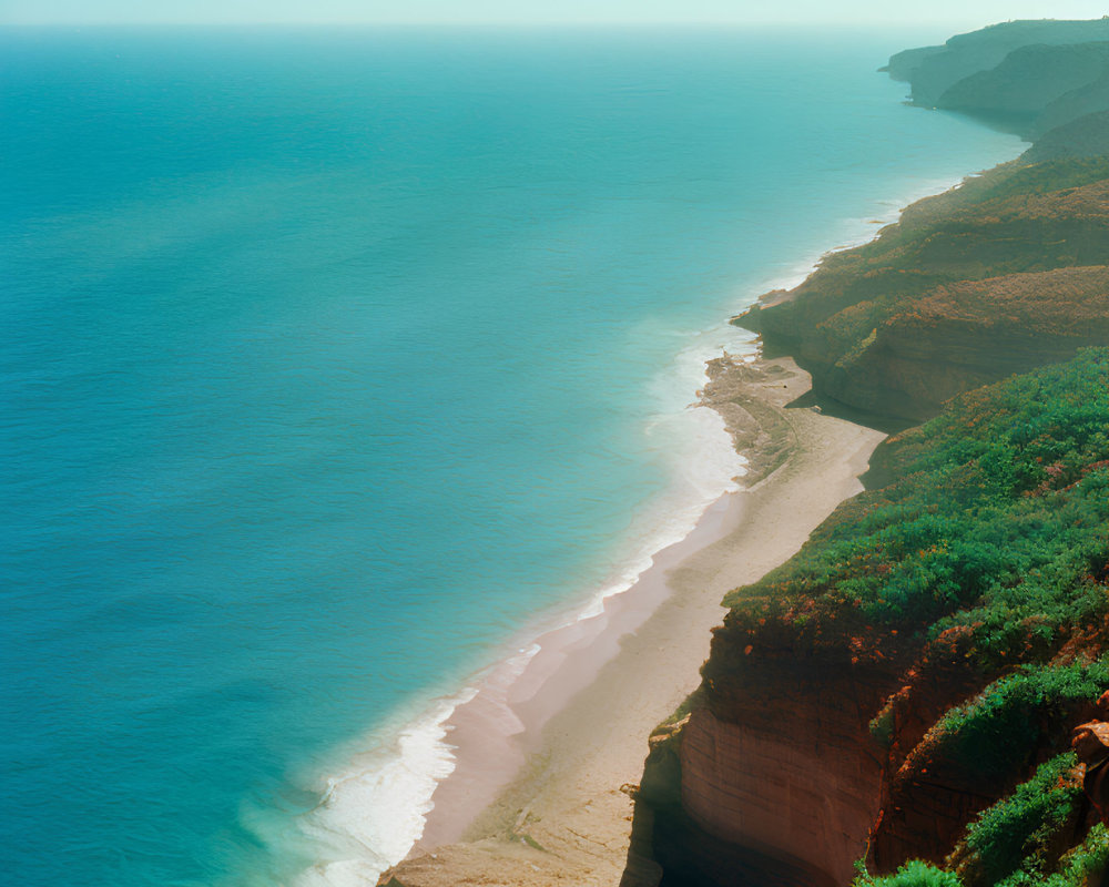 Aerial View of Coastline with Steep Cliffs and Sandy Beach