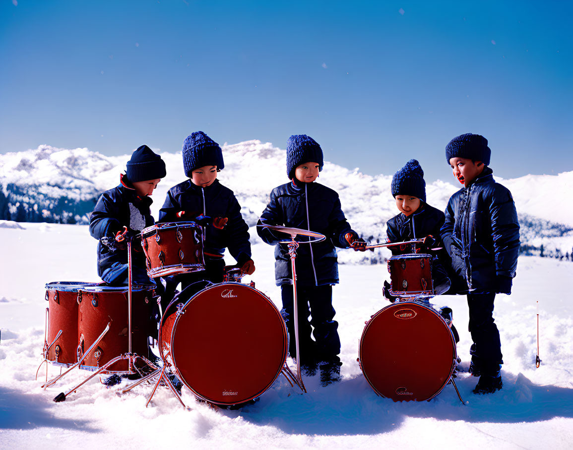 Children playing with red drum set in snowy mountains