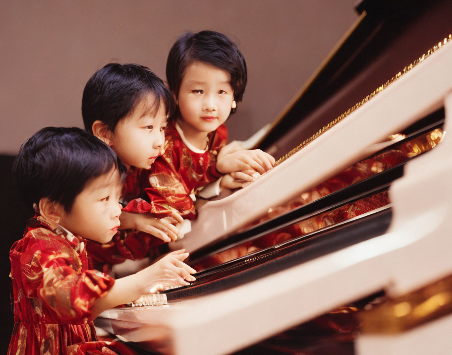 Children in Red Patterned Dresses Playing Grand Piano