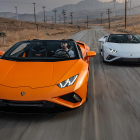 Two Lamborghini Sports Cars Parked on Rustic Road with Hilly Landscape