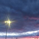 Dramatic sky with bright star over castle silhouette at sunset