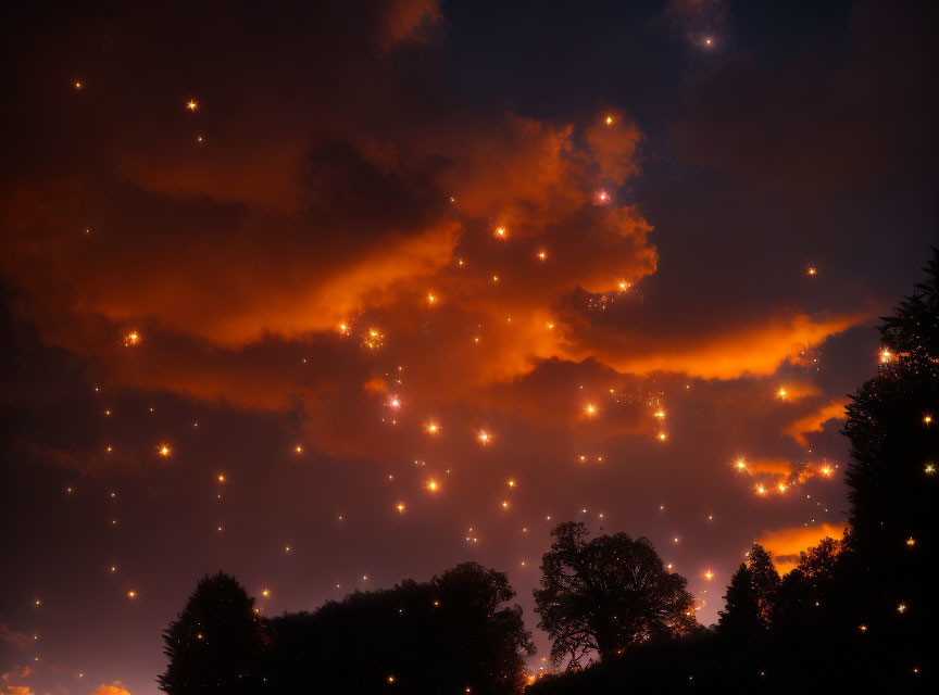 Twilight sky with orange clouds and silhouetted trees under small lights