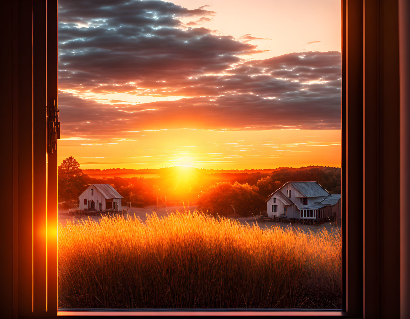 Scenic sunset view through open window with golden light on field and silhouetted houses