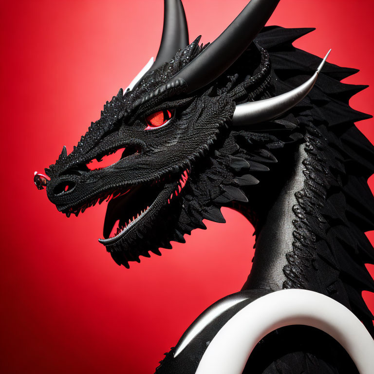 Detailed Black Dragon Model with Red Eyes and Sharp Horns on Red Background