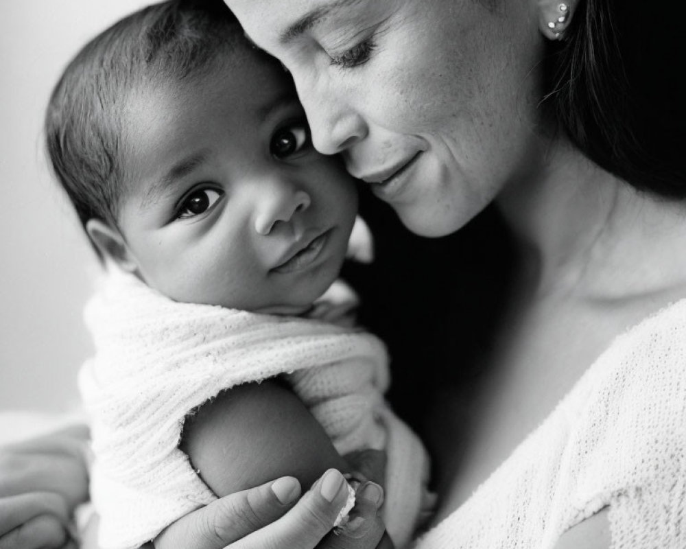 Monochrome photo of serene mother and baby cuddling