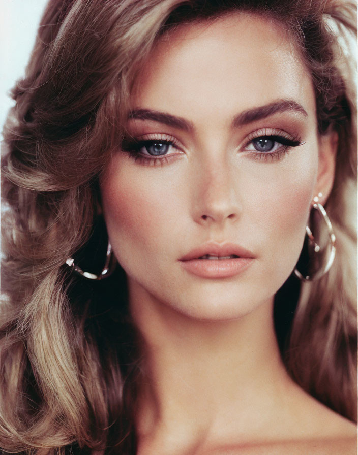 Portrait of Woman with Wavy Blonde Hair and Striking Blue Eyes