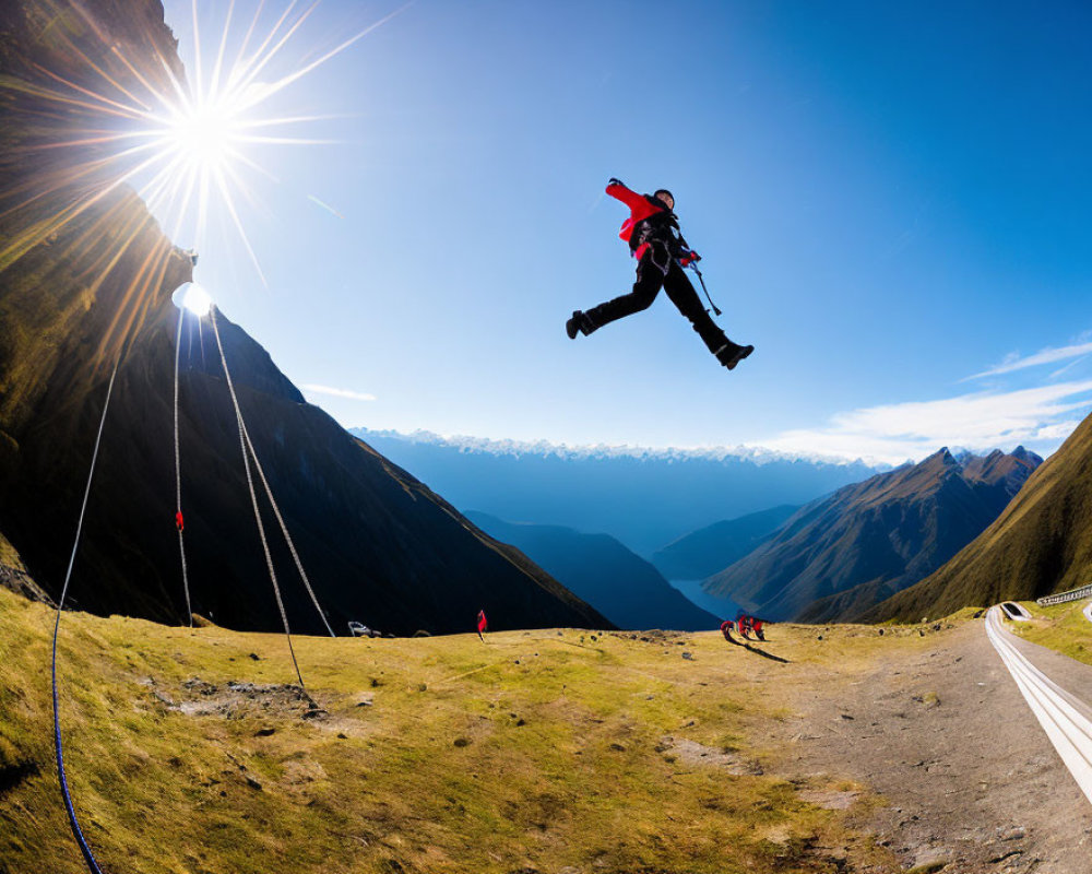 Person in Red Jacket Base Jumping off Mountain Cliff in Bright Sun