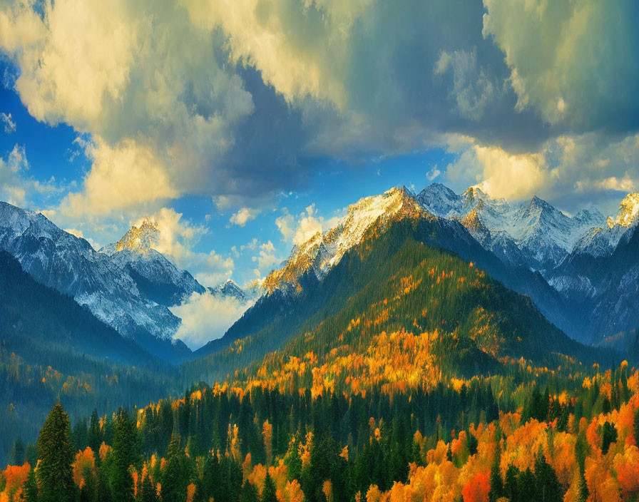 Snow-capped mountain range with autumn forest and dramatic sky