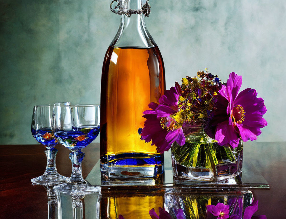 Amber liquid bottle, glasses, flowers on reflective surface