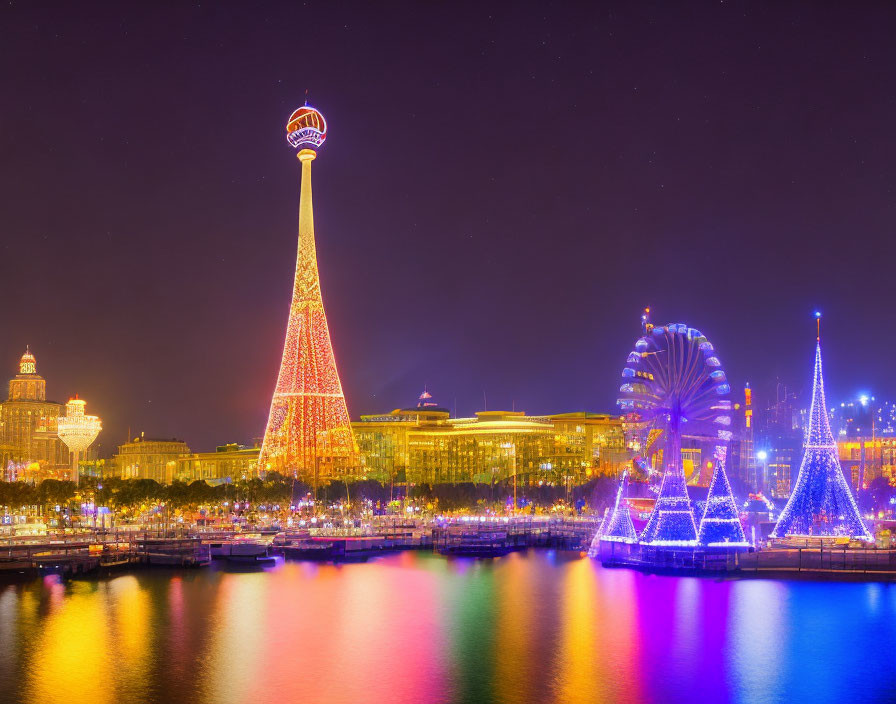 Colorful illuminated night scene with tower, Ferris wheel, and reflections.