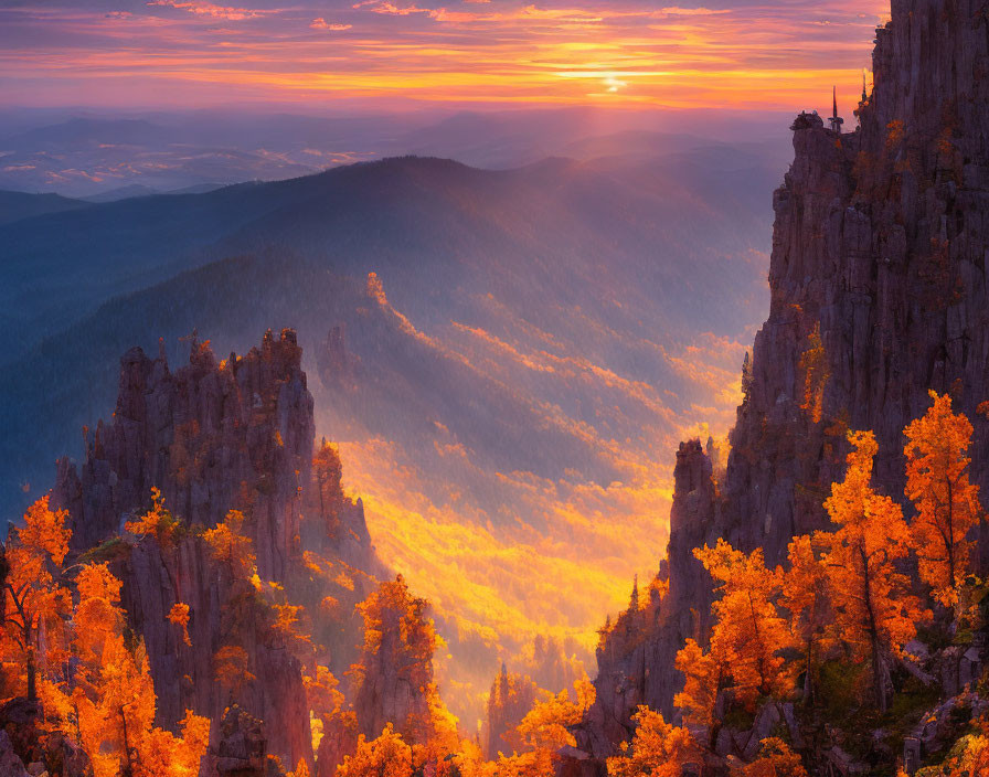 Vibrant sunset over autumn forest with rock formations and person on cliff edge