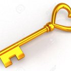 Golden key with heart-shaped bow on cryptic script background.