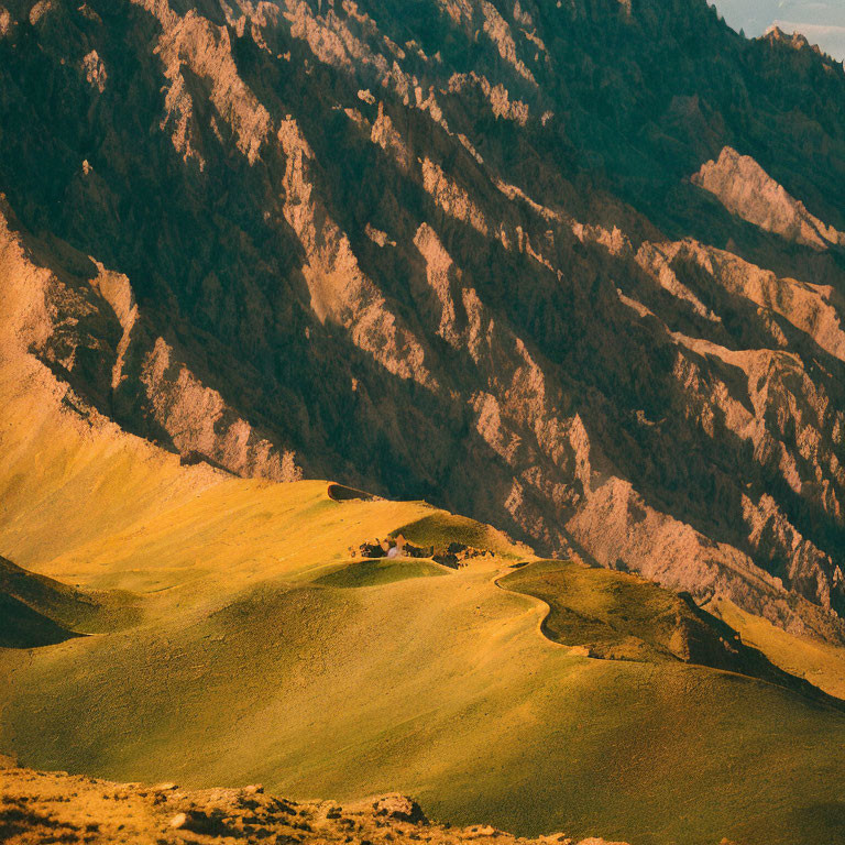 Sunlit hills and rugged mountains in serene landscape