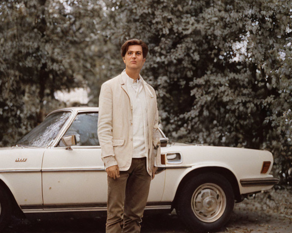 Man in Beige Jacket Standing by Vintage Car Under Trees