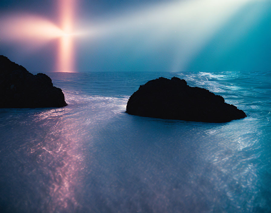 Dark Rocks in Shimmering Blue Waters at Serene Nightscape