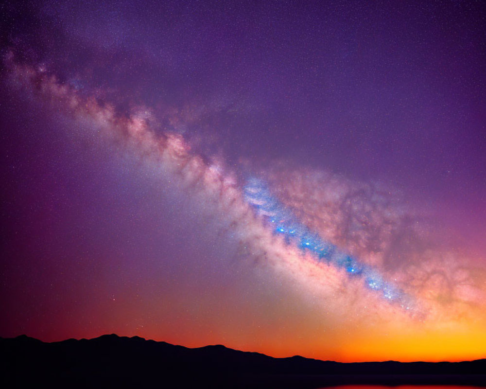 Colorful Milky Way galaxy over silhouette mountains at night