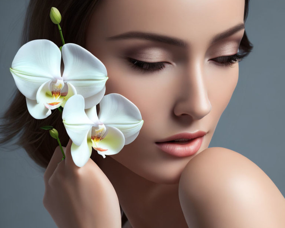 Woman with Subtle Makeup Holding White Orchid for Beauty and Elegance