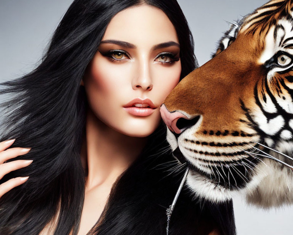 Dark-haired woman with bold makeup close to a tiger's nuzzle.