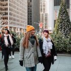 Two Women with Parasols in Festive Christmas Street