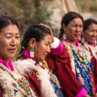 Four women in regal Renaissance attire with intricate headpieces against floral backdrop