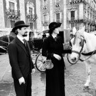 Monochrome illustration of elegantly dressed couple on vintage street