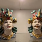 Ornate ceramic vases: stylized female heads with leaf motifs