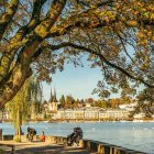 Whimsical landscape with stylized trees, oversized flowers, and sailing boats