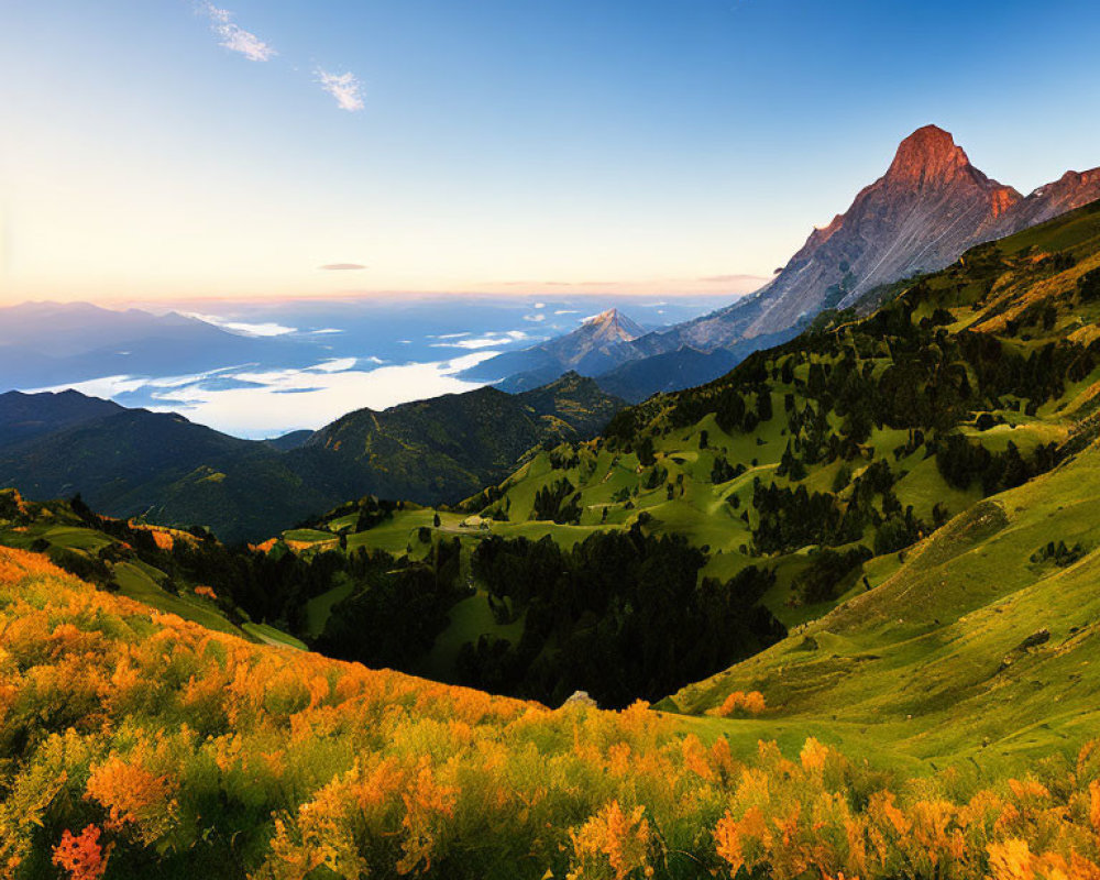 Scenic sunset view of green hills, misty mountains, and rocky peak