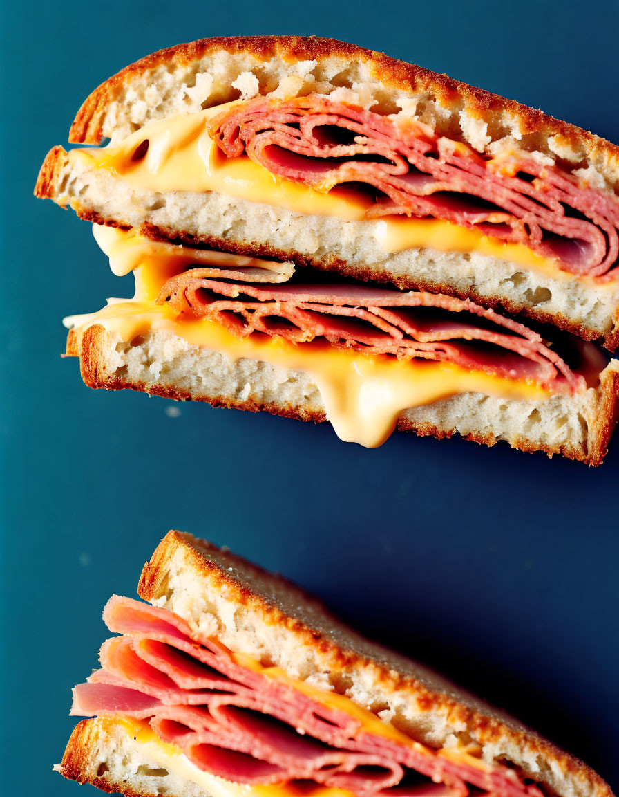 Layered Ham Grilled Cheese Sandwich on Dark Blue Background