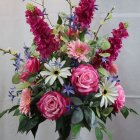 Colorful Pink and Red Flower Bouquet in Glass Vase on Starry Background