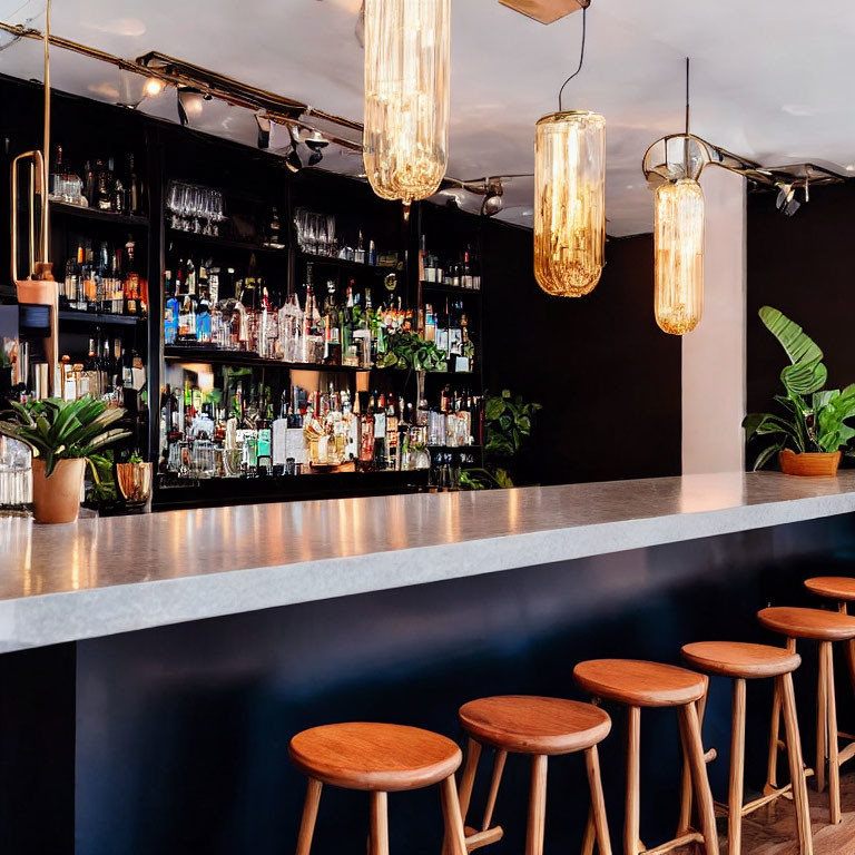 Sophisticated bar interior with marble countertop, wooden stools, backlit spirits shelf, and pendant