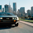 Vintage car driving in city with skyscrapers, blurred background.